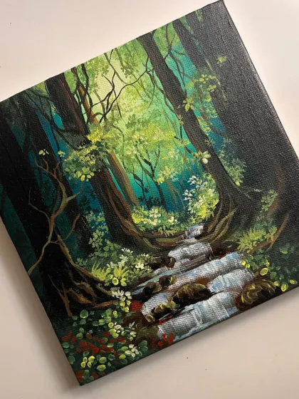 The finished "Dreamland" painting, a magical forest scene with a stream flowing through it. The colors are so vibrant and full of life.