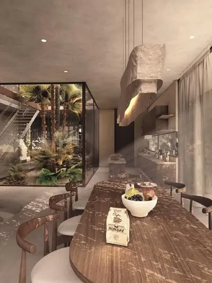 The dining area in the House of Veils is an open, flowing space connected to a sunken living pit and an internal courtyard. The design uses a mix of warm wood and cool concrete to create a balanced and serene atmosphere.