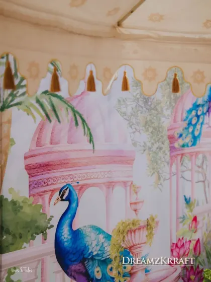 A detail of a custom-printed canopy for the Haldi, featuring beautiful watercolor illustrations of peacocks and palaces, adding an artistic and personal touch.