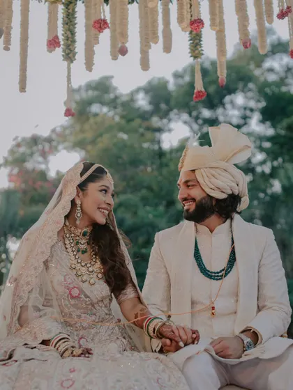 A beautiful candid moment between the bride and groom during their wedding ceremony, sharing a look of love and understanding.