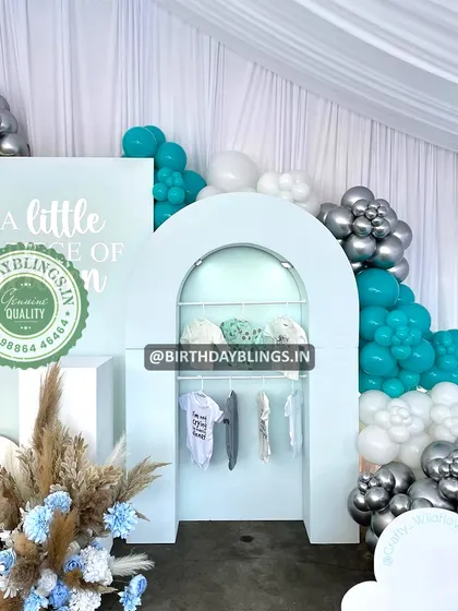 A unique detail from the "Little Piece of Heaven" shower, featuring a display arch with baby clothes.