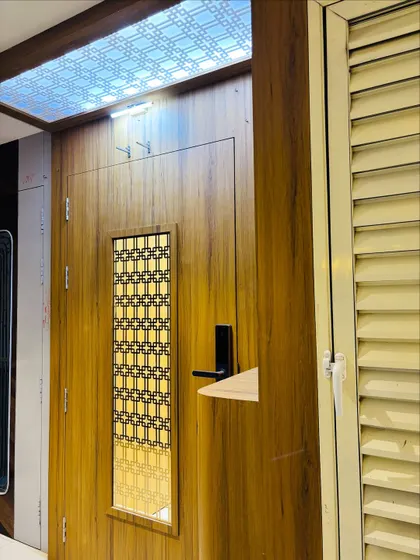 This shot highlights the beautiful effect of the backlit ceiling panel, which casts a warm glow over the entrance area.