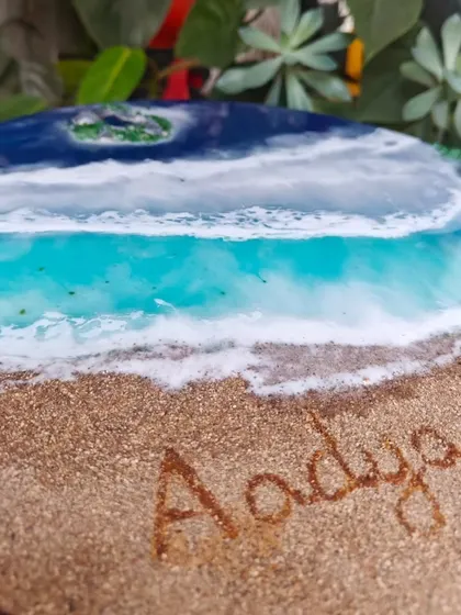 Close-up of the name 'Aadya' on the round resin nameplate.