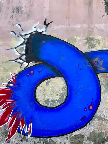 A close-up detail of the sea monster's tail, which is shaped like the number zero from '2023'.