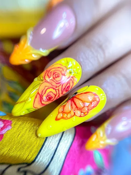 A close-up view of the hand-painted butterfly and roses, showing the delicate shading and detail work taught in our advanced art classes.
