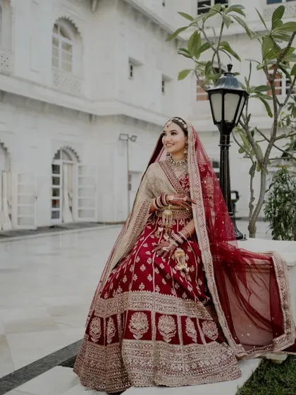 A majestic shot of my red bride. The full look, from the makeup to the lehenga, creates a stunning and royal silhouette.