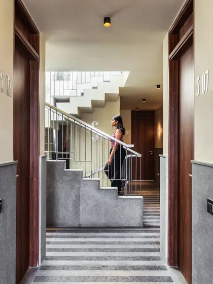 Even common areas deserve careful design. The corridors in Pixel 2 feature a "pyjama" pattern floor as a nod to the area's textile history, complemented by custom brass lights and dark wooden doors that add a touch of understated luxury.