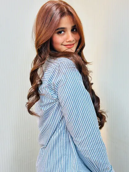 A happy client with a beautiful smile and even more beautiful hair, ready for her event.