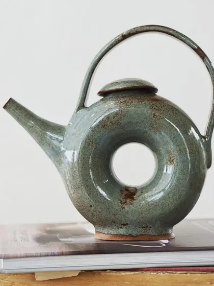 This donut-shaped teapot is a perfect example of the creative and complex forms explored in our advanced workshops. We encourage students to push the boundaries of conventional pottery.