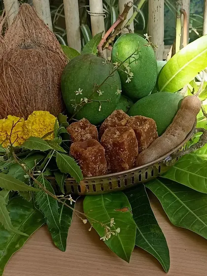 A close-up of the Ugadi platter, with neem flowers, jaggery, mangoes, and tamarind.
