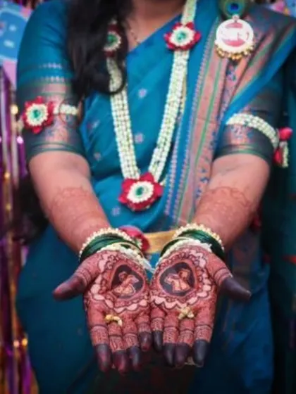 A baby shower mehendi featuring portraits of the expecting parents. This is a wonderful way to personalize the design and make the occasion even more memorable.