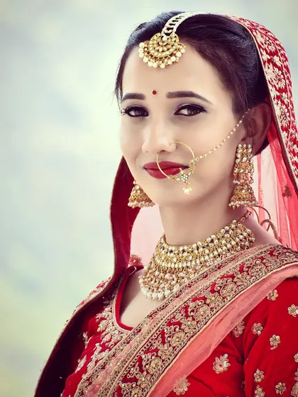 A clean and simple bridal portrait, focusing on the bride's happy expression and classic makeup.