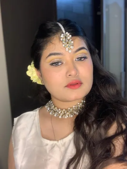 A close-up of the winged eyeliner and pastel yellow shadow.