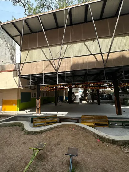 The view of the classroom extension from the sandpit, showing the relationship between the play area and the sheltered space below the classroom.