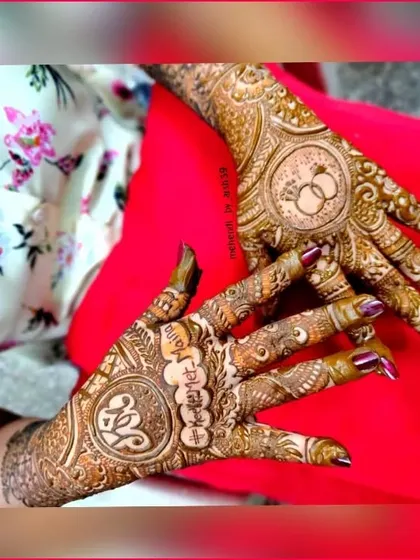 A personalized bridal design featuring the bride's name, "Mahina," and the couple's initials "M" and "K" in a heart. The other hand features a classic engagement ring motif.