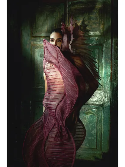 A full-body shot where the model's pose echoes the dramatic, flowing shape of the couture piece. This synergy between model and garment is something I focus on in my creative direction.
