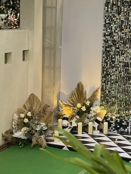 Another view of the corner floral arrangements, showing the beautiful texture and modern aesthetic of the dried foliage mixed with fresh flowers.