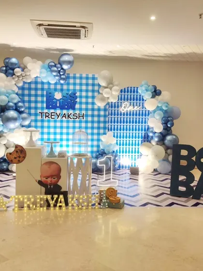 A wide shot of the Boss Baby first birthday party, showing the full setup with marquee letters and themed backdrop.