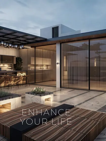 This terrace design seamlessly connects an indoor kitchen and bar with an outdoor lounge area. Featuring large glass sliding doors, marble planters, and custom wood seating, it's a versatile space designed for entertaining and enjoying the evening sky.