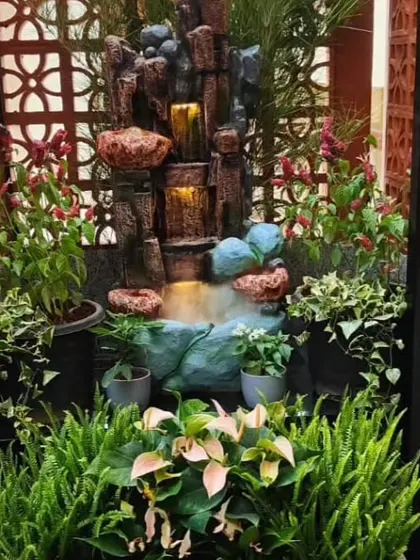 A compact, self-contained water fountain feature for a small terrace or balcony corner. I surrounded it with ferns and other moisture-loving plants to create a tranquil micro-oasis.