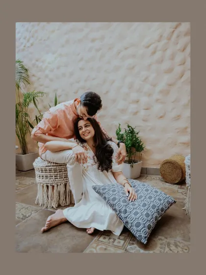 A tender moment with the groom kissing the bride's forehead as she relaxes, a beautiful portrait of love and care.