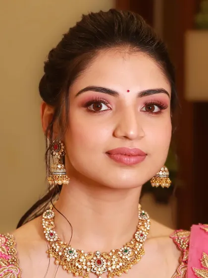 A direct portrait showing the symmetry and precision of the makeup application. The soft pink tones give her a romantic and ethereal glow.