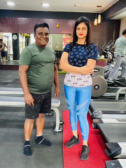 A similar pose, but the commitment is the same. Posing with actor Mithra in the weights area.