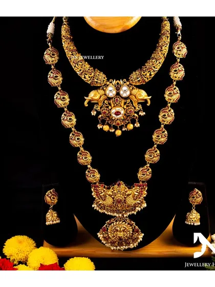 A stunning bridal set with elephant motifs on the choker and a peacock pendant on the long necklace. A beautiful blend of traditional designs.