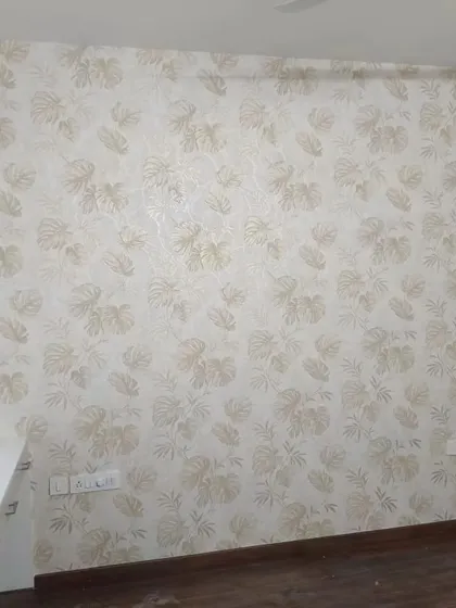 A subtle and elegant wallpaper with a faint leaf pattern in neutral tones. This is perfect for adding texture to a room without a bold pattern.