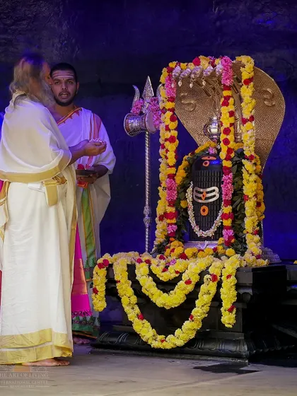 I am performing a puja at the Shiva Lingam in our ashram temple. These daily and weekly rituals maintain the spiritual vibrancy of this sacred space.