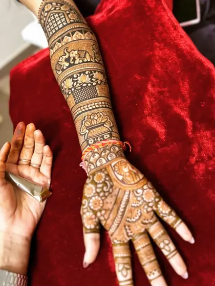 A single arm view of a detailed bridal design, showing how I incorporate traditional elements like kalash and elephants into the flow of the pattern.