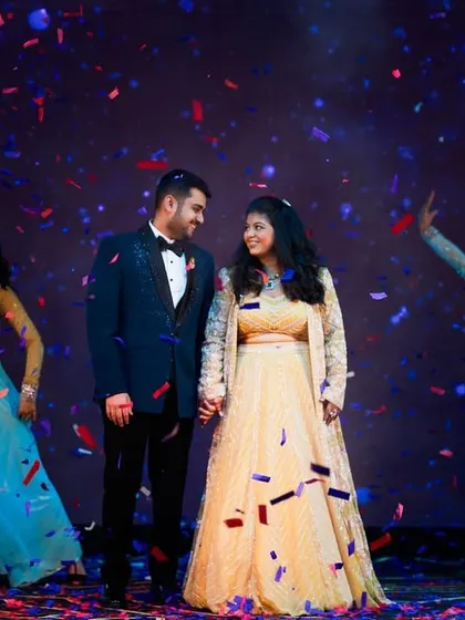 The final pose of a couple's dance, surrounded by confetti and their dance troupe. We plan for picture-perfect endings.