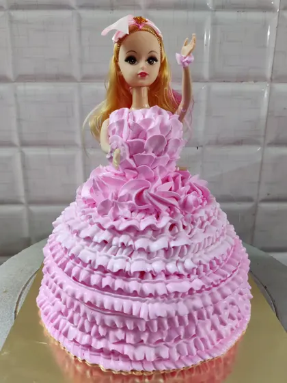 Another one of my popular doll cake designs. This one features a full pink ruffled buttercream gown, perfect for a princess-themed party.