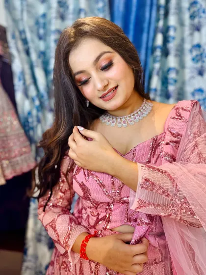 Pretty in pink. This shot highlights the beautiful makeup and diamond-look jewelry that pairs perfectly with the sequined outfit.