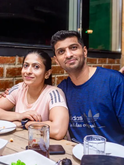 A couple enjoying a relaxed dinner. My pub offers both high-energy party zones and cozier spots for a quieter evening.