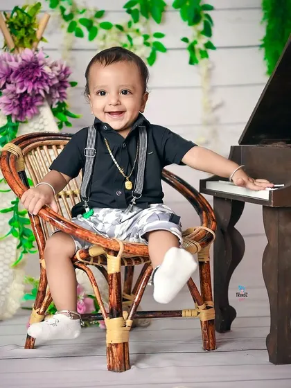 A duplicate of image 94, a happy toddler enjoying his birthday shoot.