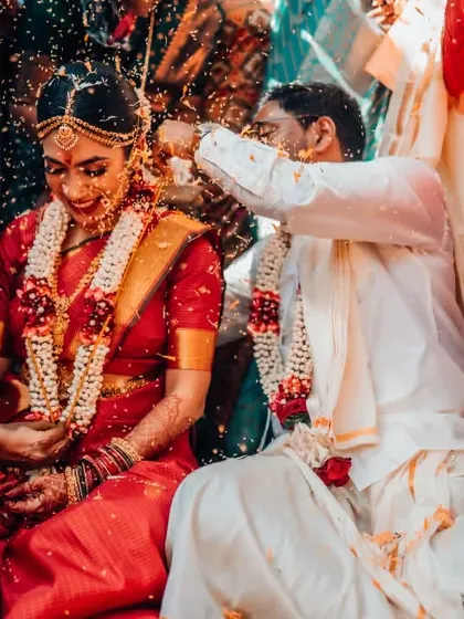 The 'talambralu' ritual in a South Indian wedding, where the couple showers each other with rice and pearls.