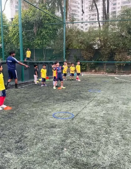 A group of young players listens to their coach's instructions. Discipline and respect are the foundations of our training program.
