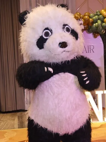 A panda mascot adds a playful and interactive element to a jungle-themed birthday party.