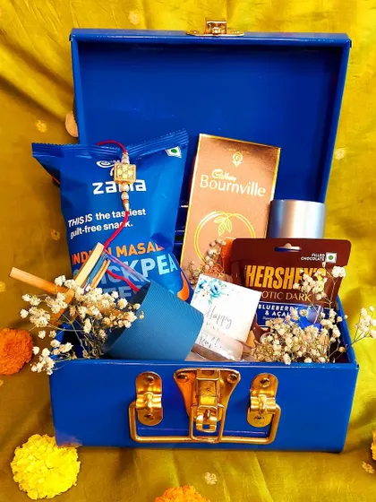 A simple yet thoughtful Rakhi gift for a brother. This mini trunk is filled with his favorite snacks and a small gift, showing that even small gestures can mean a lot.