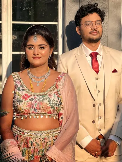 The happy couple. The bride's soft and subtle makeup looks beautiful in the natural sunlight, complementing her groom's classic suit.