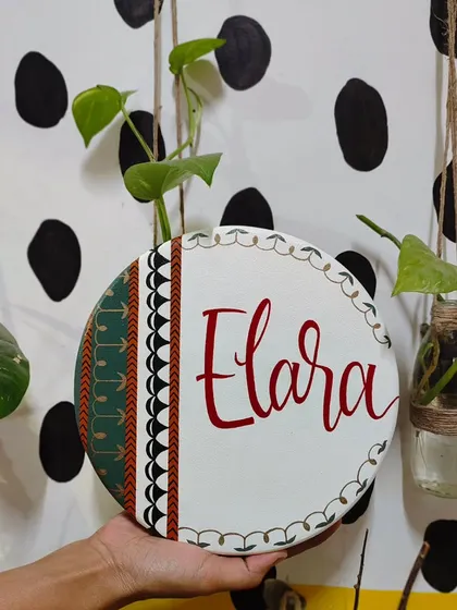 A full view of the "Elara" name plaque, showing how the traditional patterns and colors come together. This piece is a beautiful fusion of heritage and modern design.