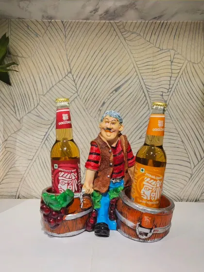 This bottle holder features a man relaxing between two barrels, perfect for holding wine or beer bottles in your home bar setup.