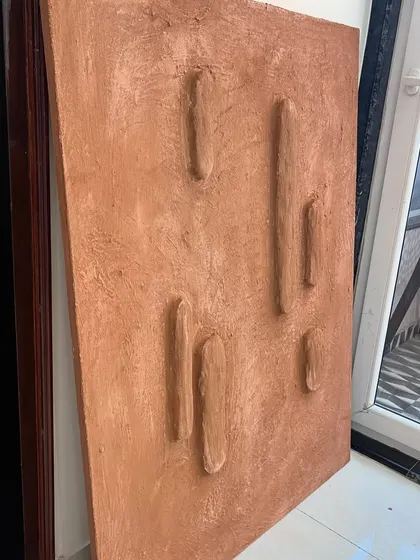 This terracotta-colored textured piece was one of three created for Sidewalk cafe in Agra. The raised, organic shapes and earthy tones were chosen to complement the cafe's decor.