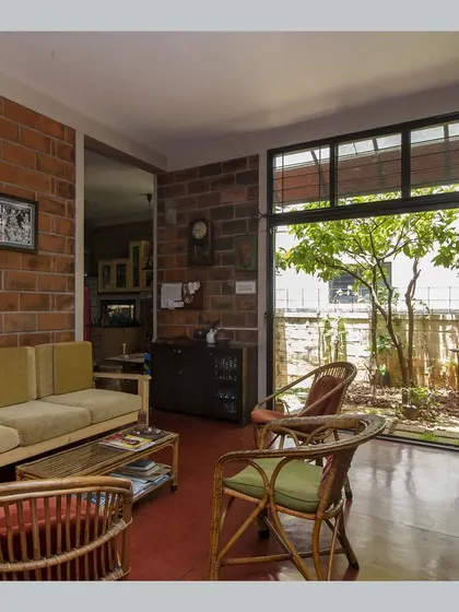 A view of the living room showing its connection to an internal garden, bringing nature right into the heart of the home.