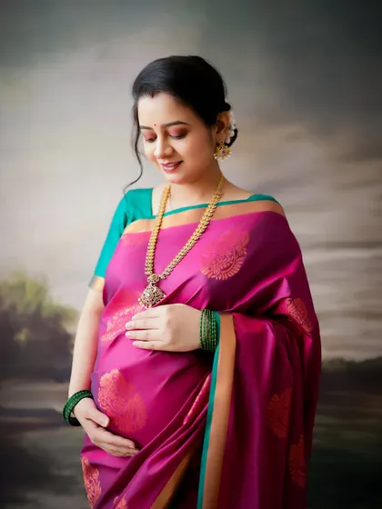 A duplicate of image 208, this traditional portrait of a mom-to-be in a silk saree is peaceful and classic.