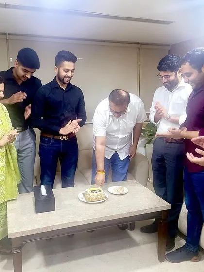 We work hard, and we celebrate our successes as a family. Here, our team celebrates a senior's birthday in the office, reinforcing the strong bonds that make our workplace a supportive environment.