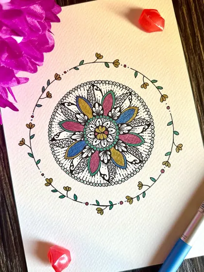 This floral mandala is surrounded by a delicate, hand-drawn vine. The soft colors and nature-inspired elements combine to create a piece that feels like a gentle breath of fresh air.