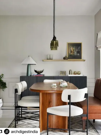 A dining space from the Madras pied-à-terre project by Weespaces, featured in Architectural Digest. We created the sleek, black fluted sideboard with a brass base and the unique dining chairs to fit the home's compact, open-plan design.