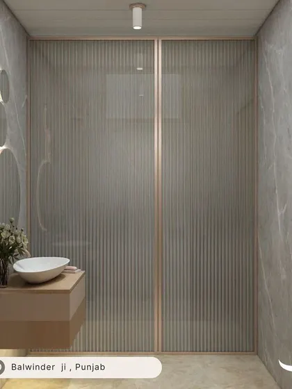 A luxurious bathroom design for our client Balwinder in Punjab, featuring fluted glass partitions and dramatic grey marble walls for a sophisticated and modern look.